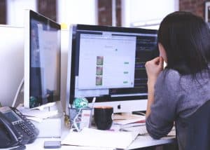 Woman Programming a Computer Program on Desktop