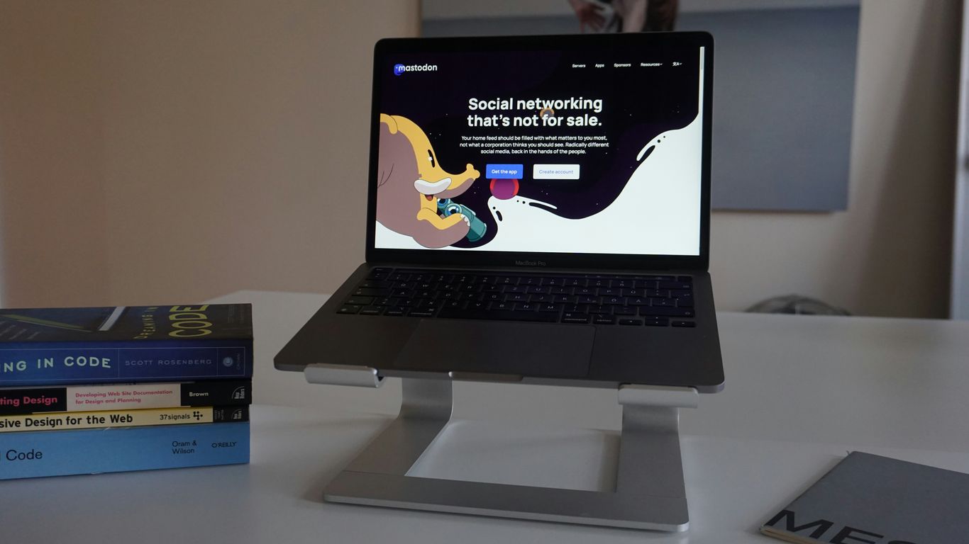a laptop computer sitting on top of a white desk