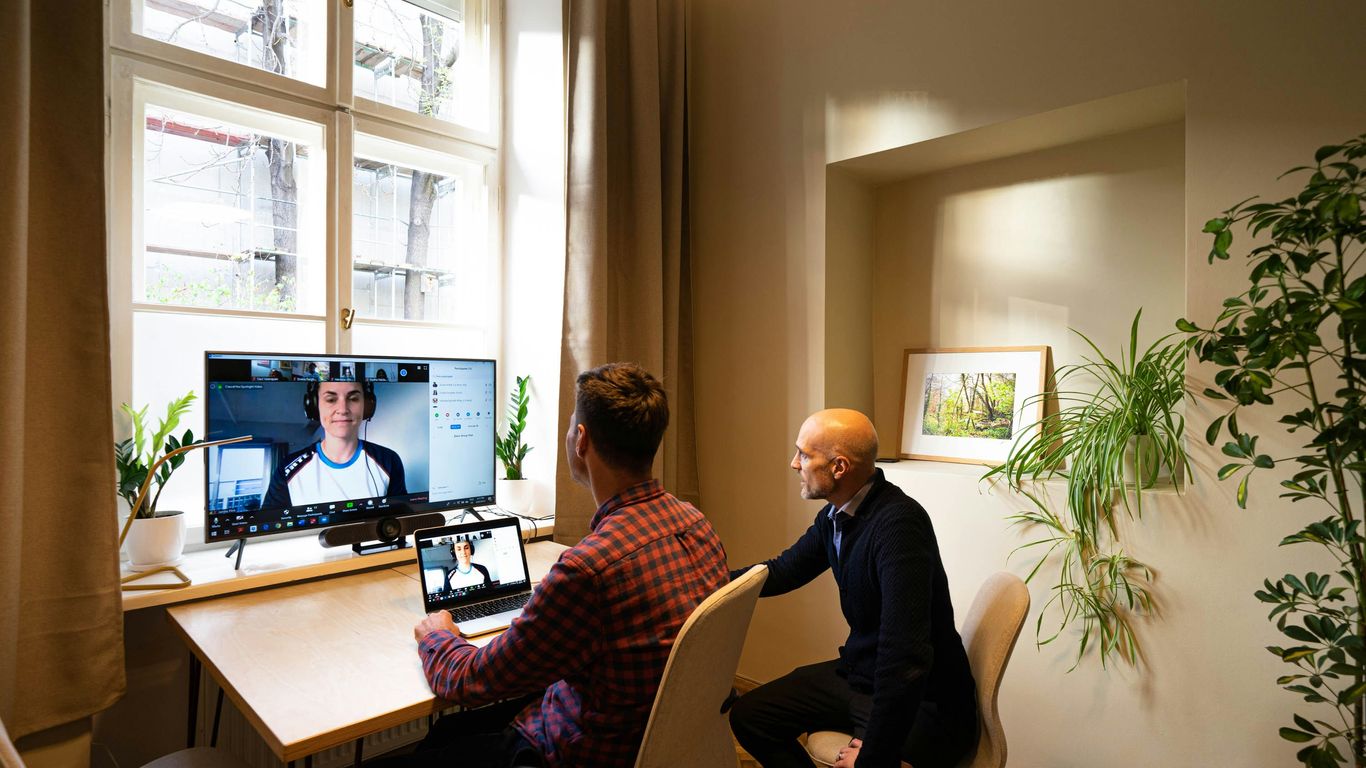 man in black long sleeve shirt sitting on chair in front of computer