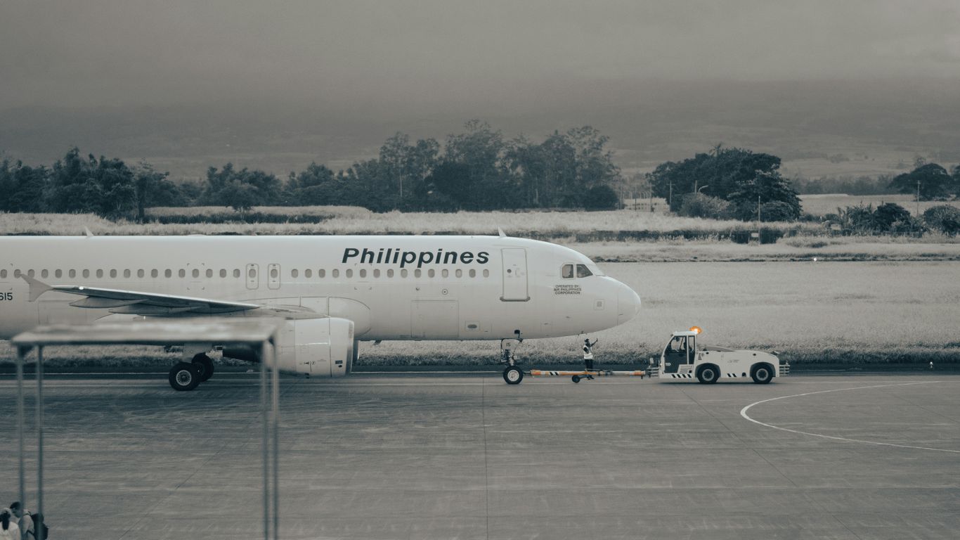 An airplane is parked on the runway at the airport