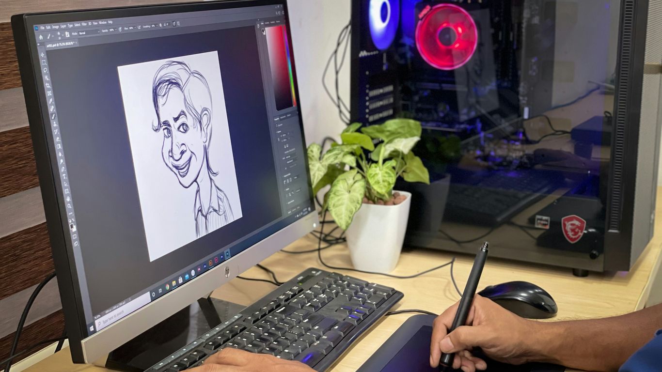 person using computer on brown wooden desk
