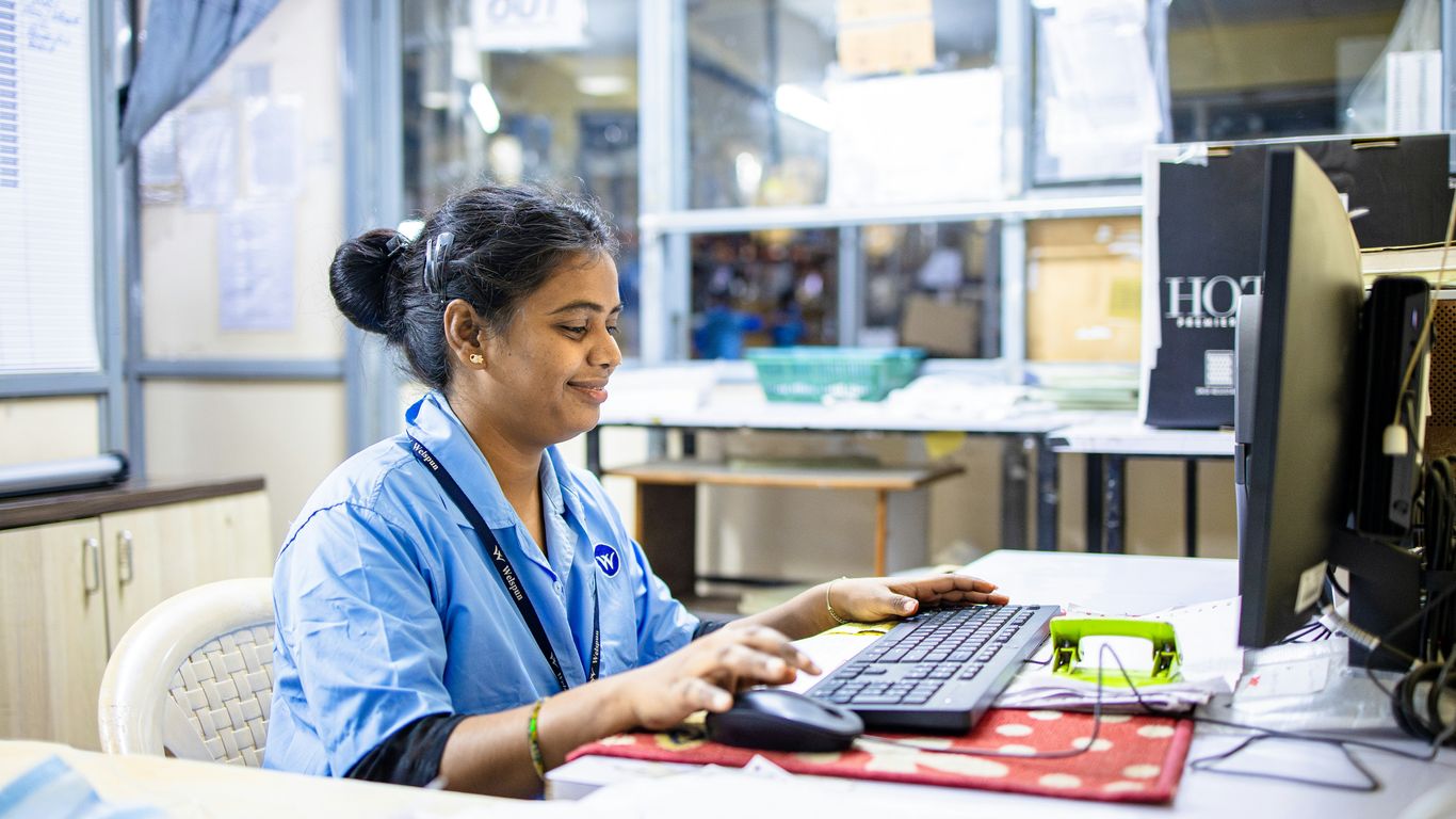 Woman works on a computer in an office.