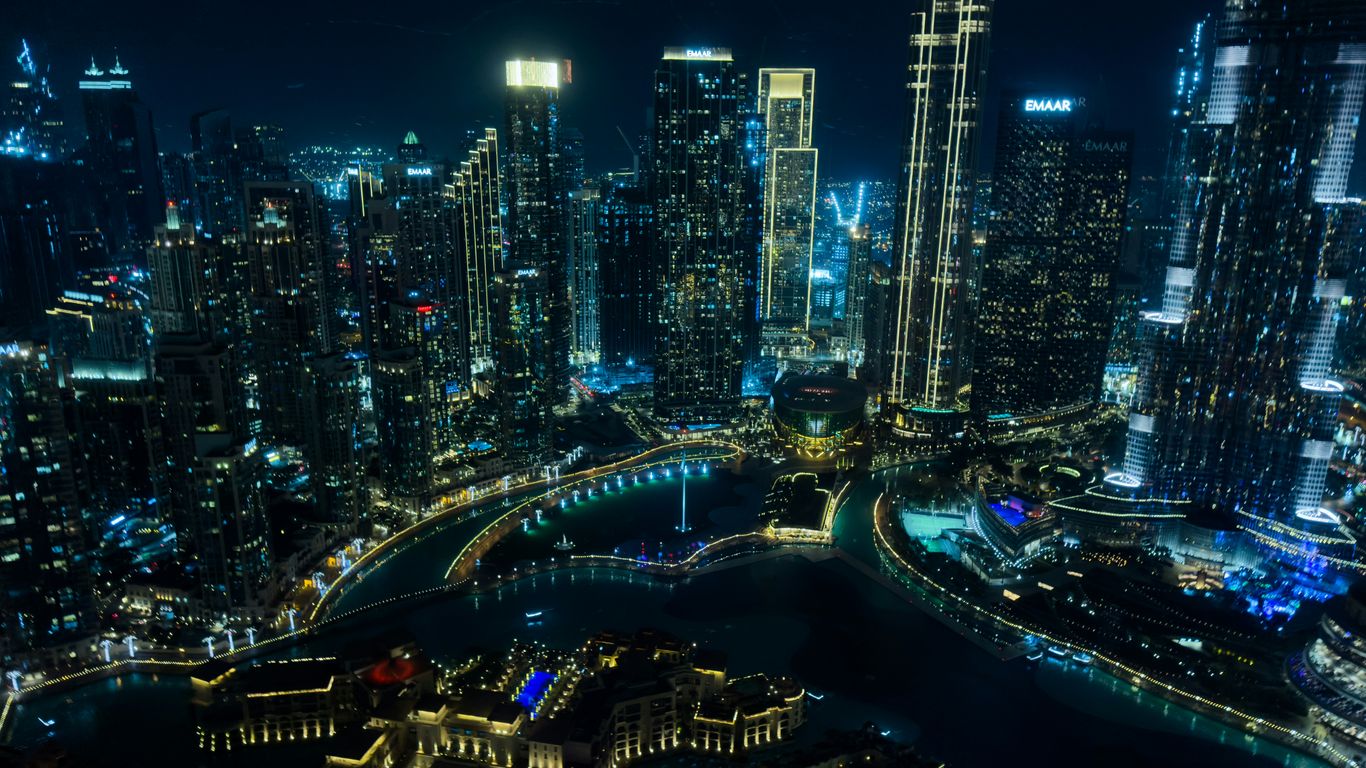 Modern cityscape with illuminated skyscrapers at night