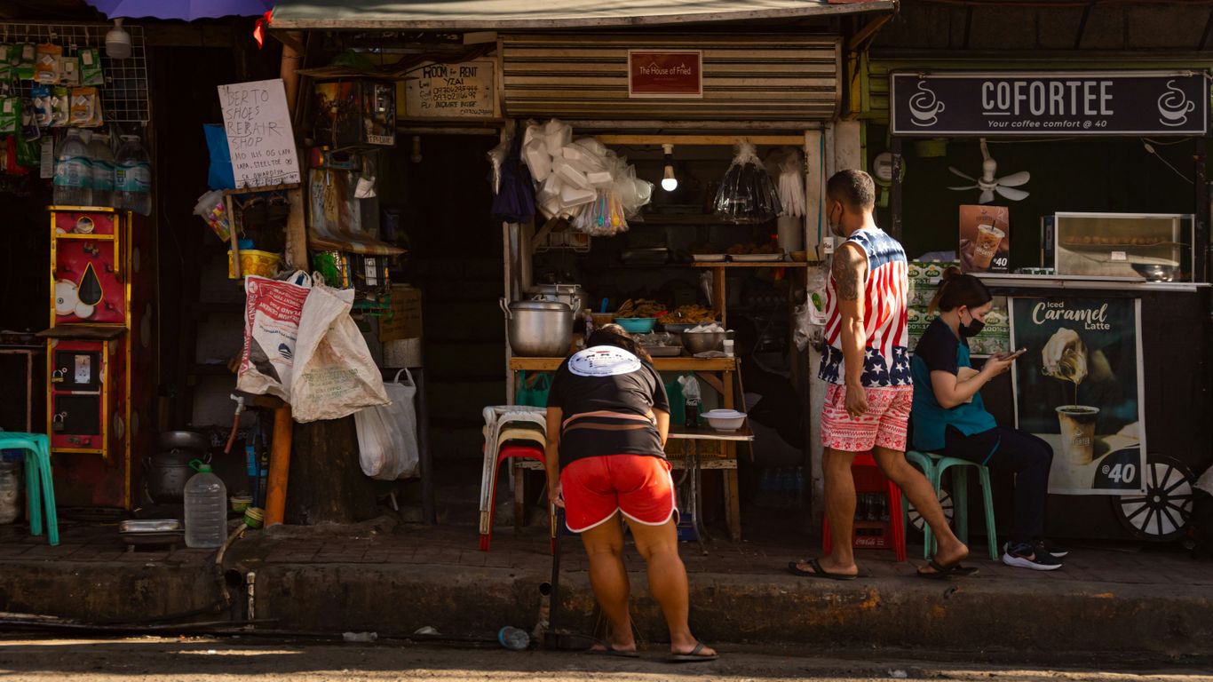 a man standing in front of a coffee shop