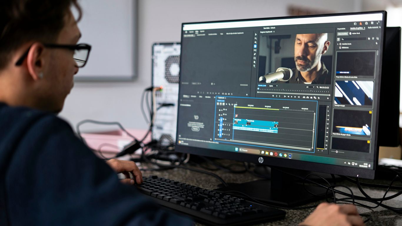 A person edits video on a computer.