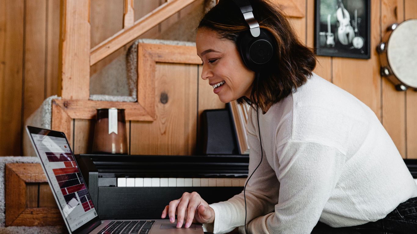 woman in gray long sleeve shirt using macbook pro